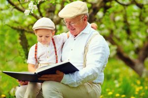 Grandfather reading to grandchild